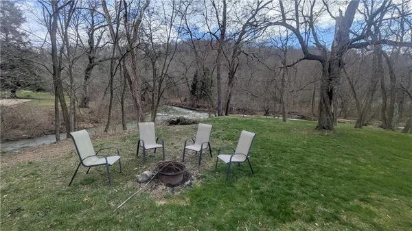 a view of a chairs and table in backyard