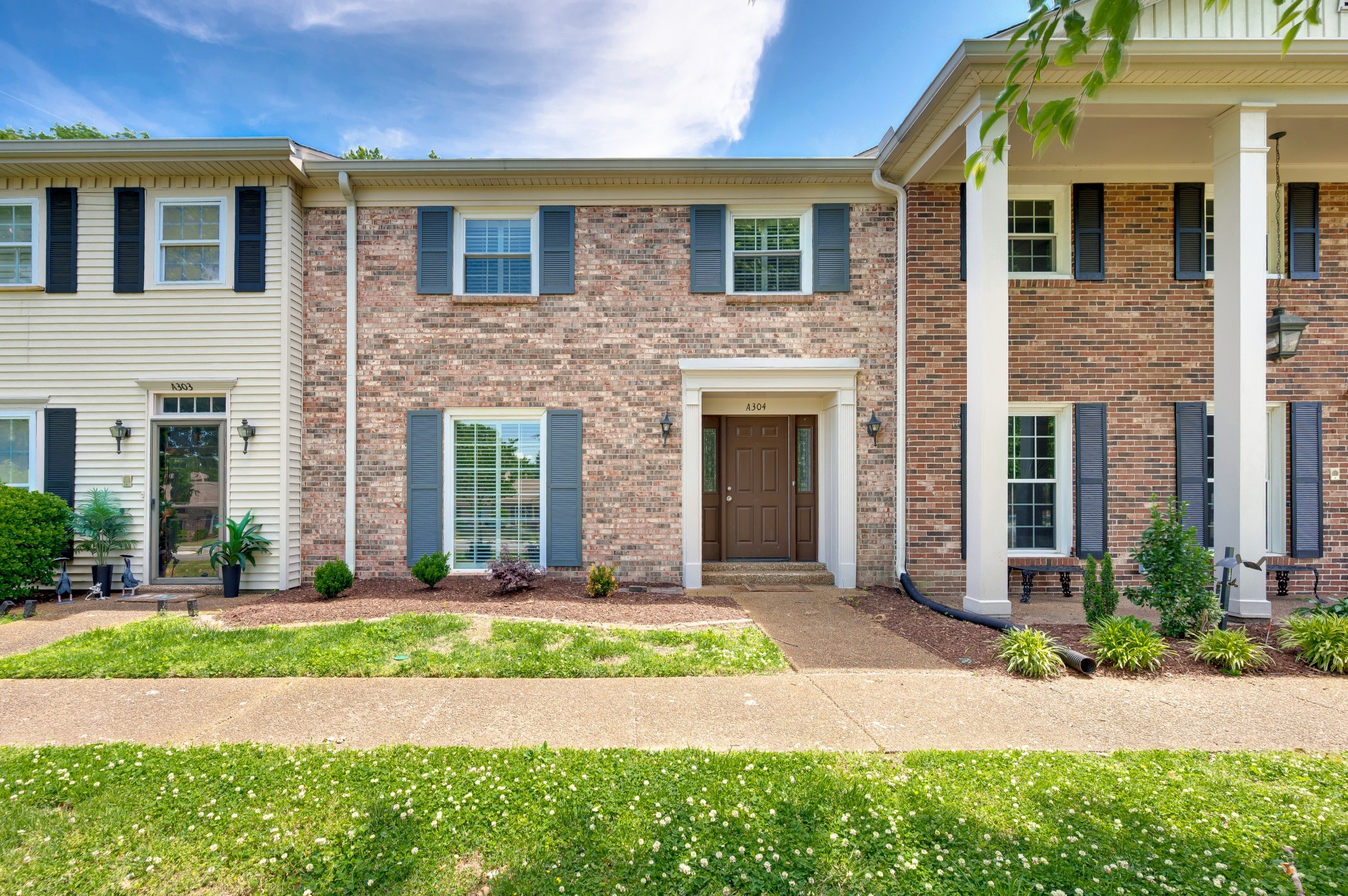 8300 Sawyer Brown Road, Unit A304 Nashville, TN 37221 - Photo 1 of 57 a front view of a house with yard and tress