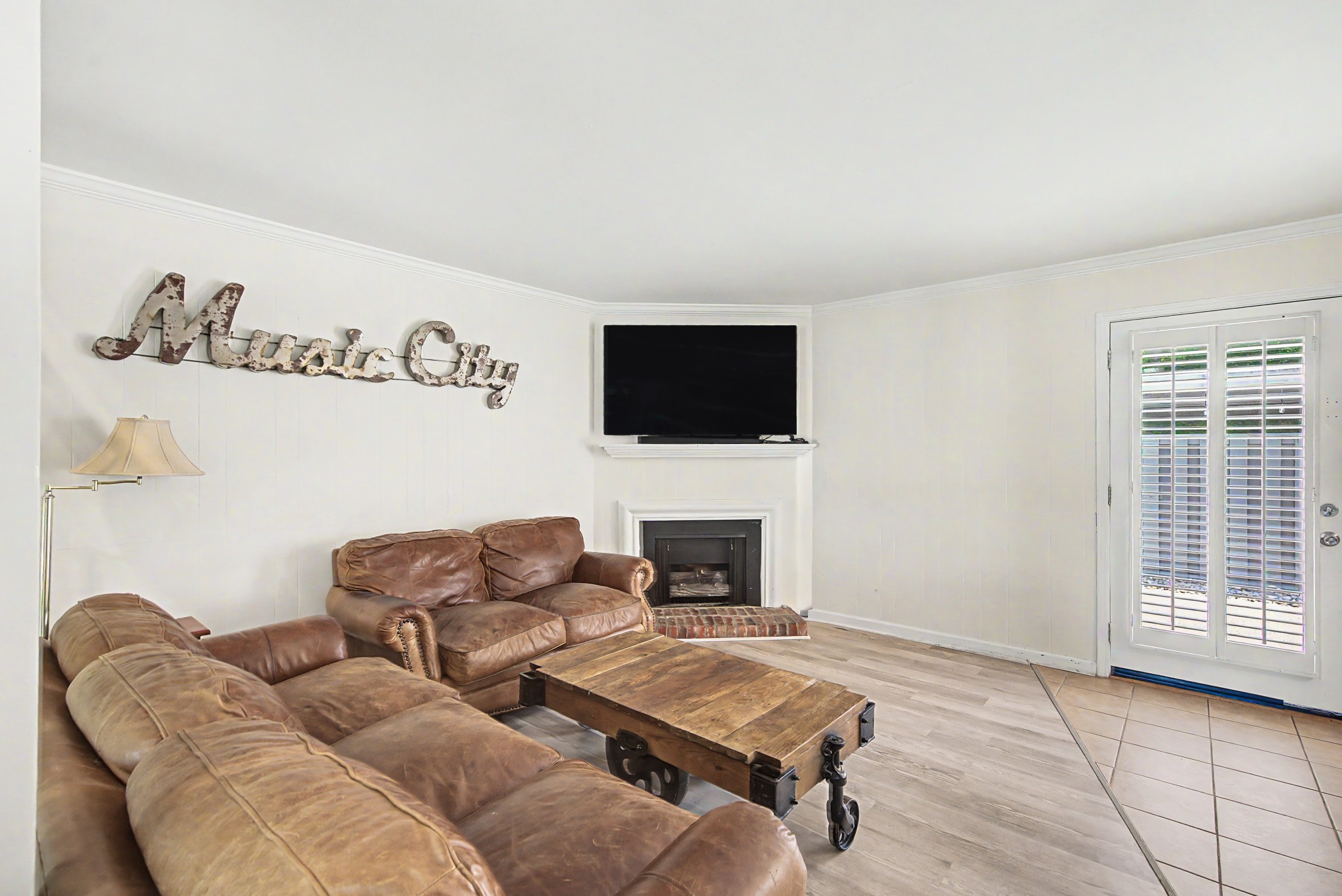 8300 Sawyer Brown Road, Unit A304 Nashville, TN 37221 - Photo 16 of 57 a living room with furniture and a fireplace