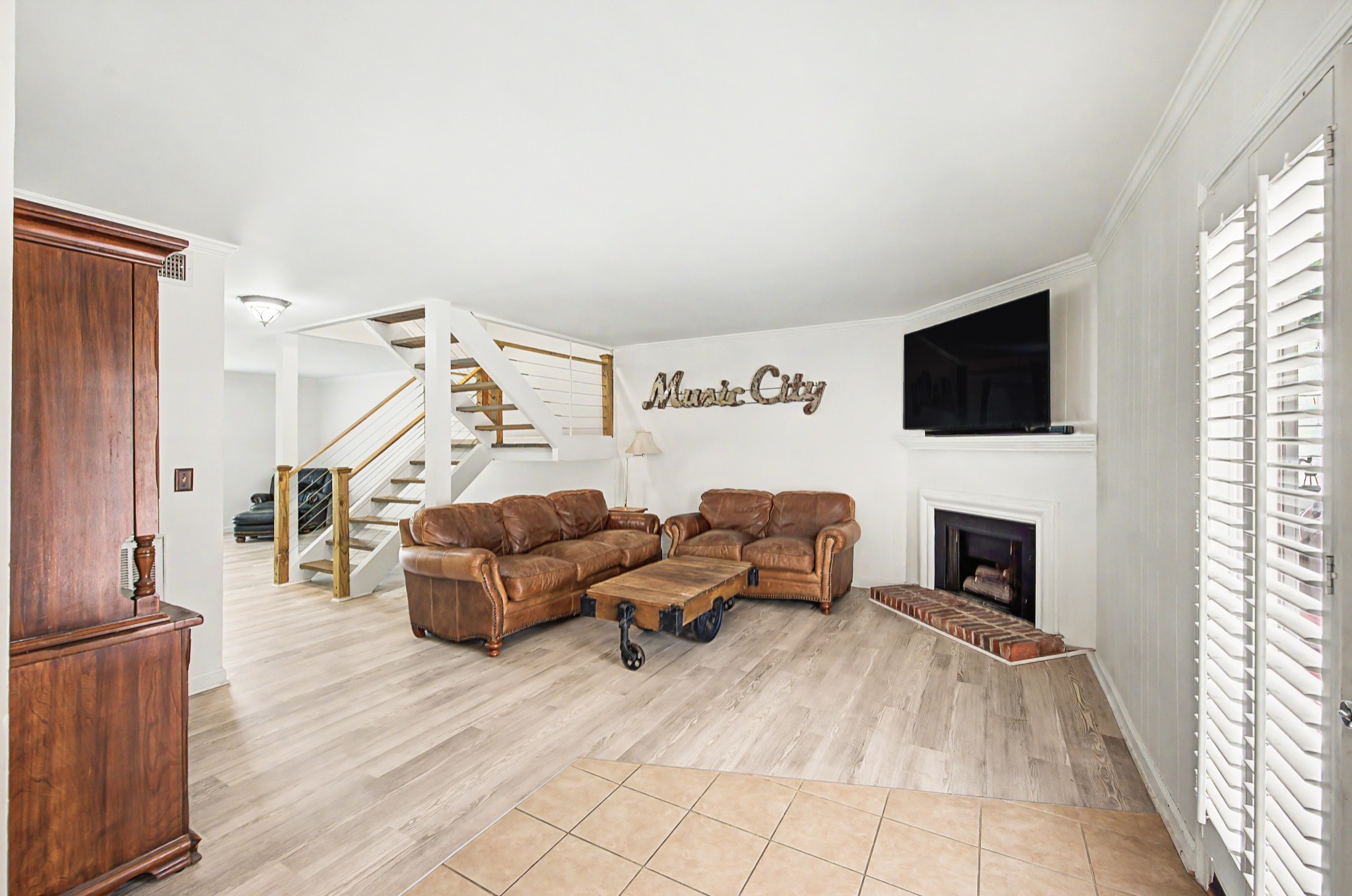 8300 Sawyer Brown Road, Unit A304 Nashville, TN 37221 - Photo 19 of 57 a living room with furniture and a fireplace
