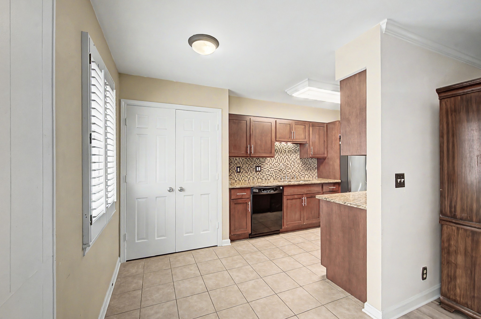 8300 Sawyer Brown Road, Unit A304 Nashville, TN 37221 - Photo 22 of 57 a kitchen with a refrigerator and a stove top oven