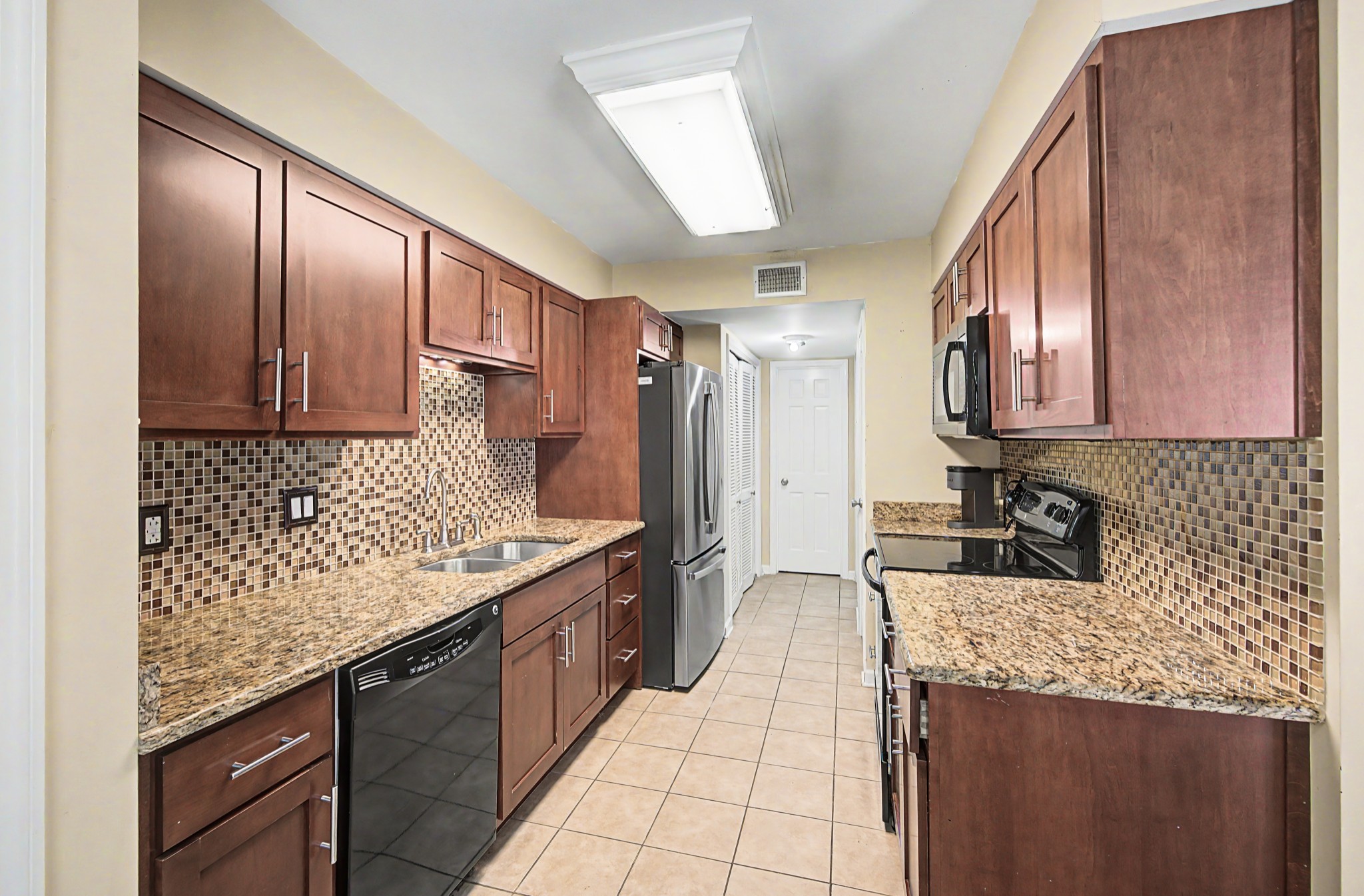 8300 Sawyer Brown Road, Unit A304 Nashville, TN 37221 - Photo 23 of 57 a kitchen with stainless steel appliances granite countertop a sink stove and refrigerator