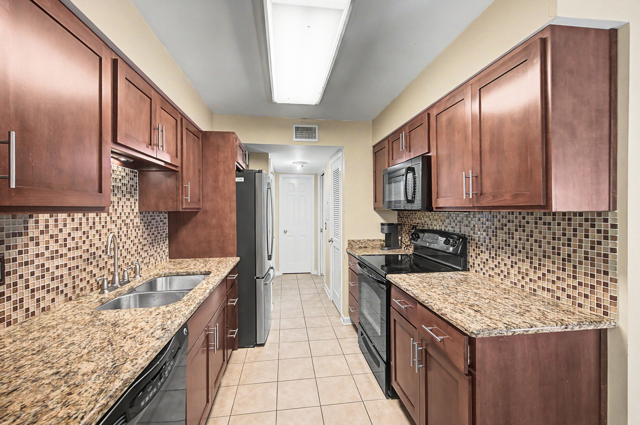 8300 Sawyer Brown Road, Unit A304 Nashville, TN 37221 - Photo 24 of 57 a kitchen with stainless steel appliances granite countertop a sink stove and refrigerator