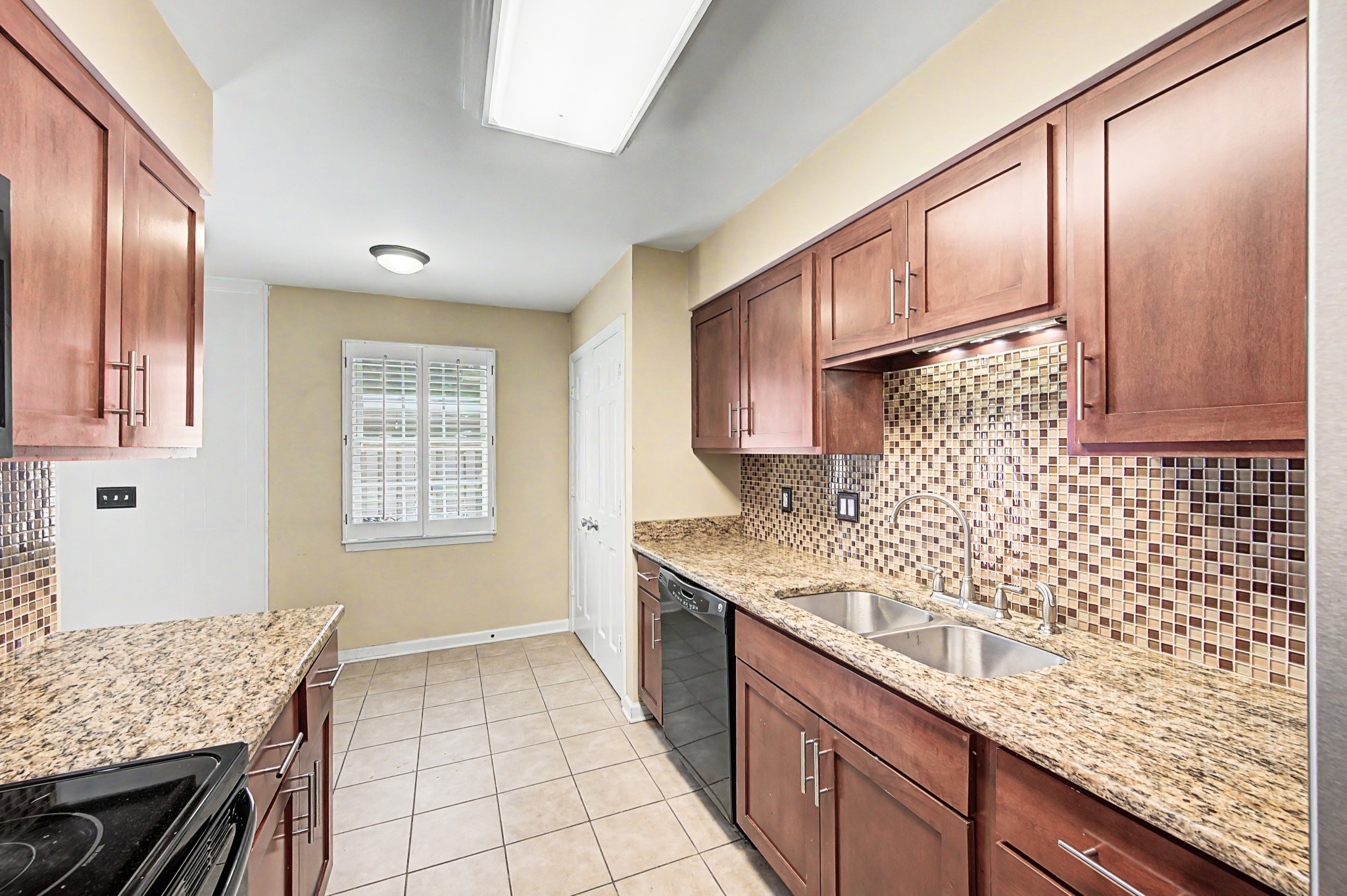 8300 Sawyer Brown Road, Unit A304 Nashville, TN 37221 - Photo 26 of 57 a kitchen with granite countertop cabinets and window