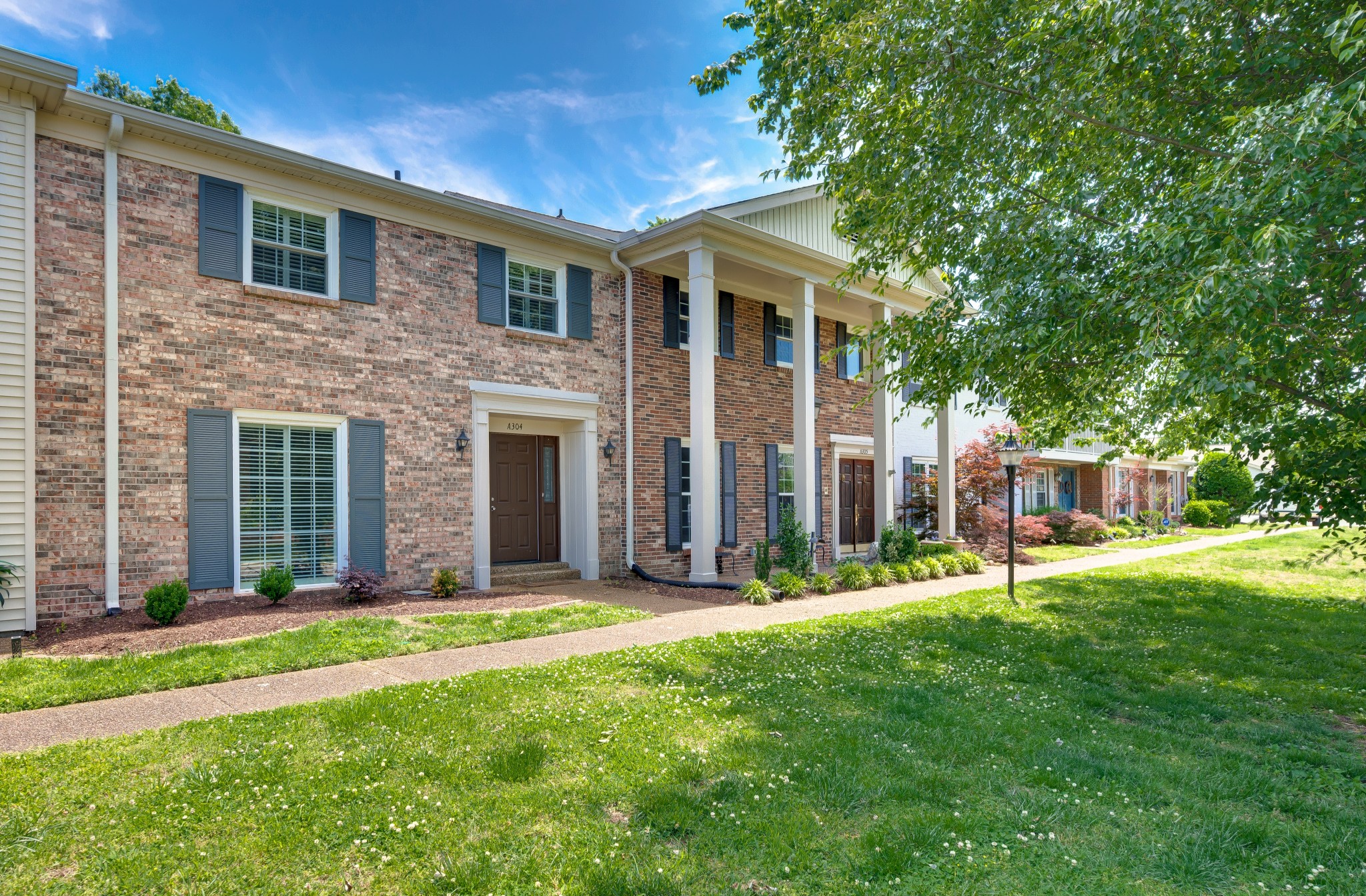 8300 Sawyer Brown Road, Unit A304 Nashville, TN 37221 - Photo 4 of 57 a view of a house with a yard and pathway