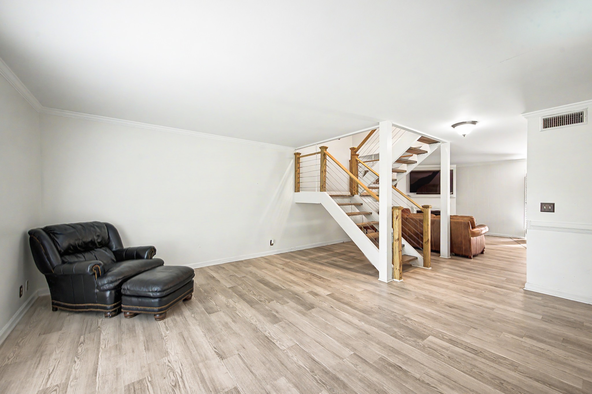 8300 Sawyer Brown Road, Unit A304 Nashville, TN 37221 - Photo 9 of 57 a living room with furniture and a wooden floor