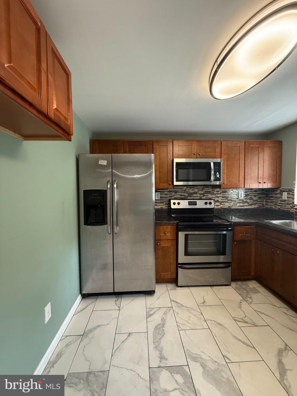 123 Winters Lane Baltimore, MD 21228 - Photo 6 of 28 Modern kitchen with sleek finishes.