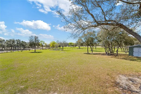 a view of a yard with a house in the background
