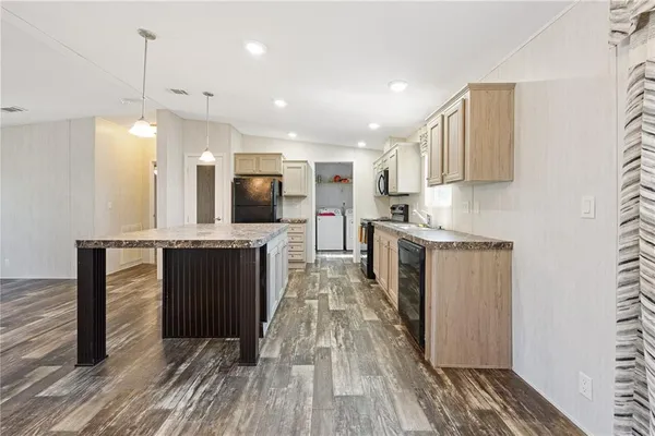 a kitchen with refrigerator and center island
