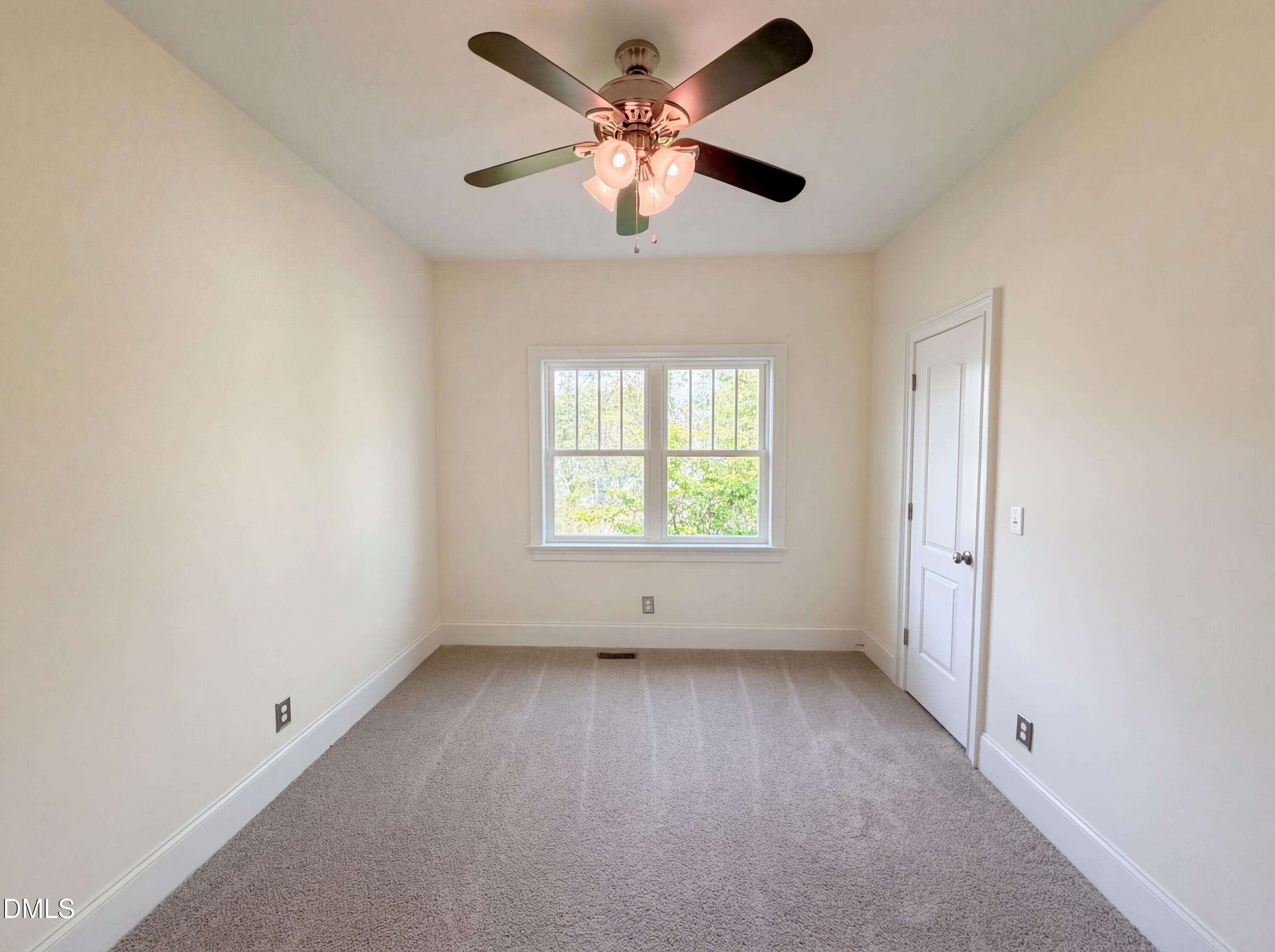 1007 Hazel Street Durham, NC 27701 - Photo 12 of 17 an empty room with a window and a fan