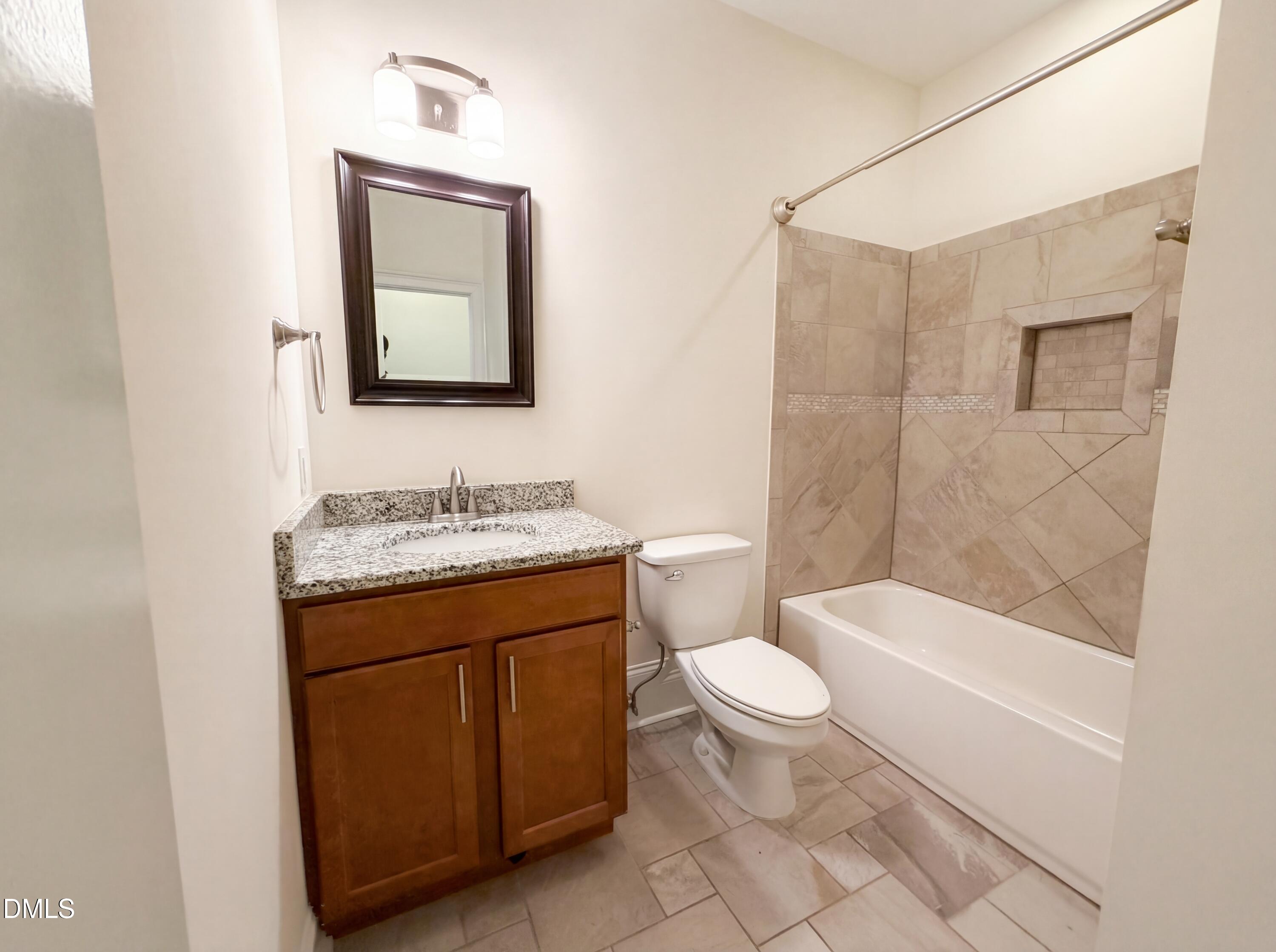 1007 Hazel Street Durham, NC 27701 - Photo 13 of 17 a bathroom with a granite countertop sink toilet and shower