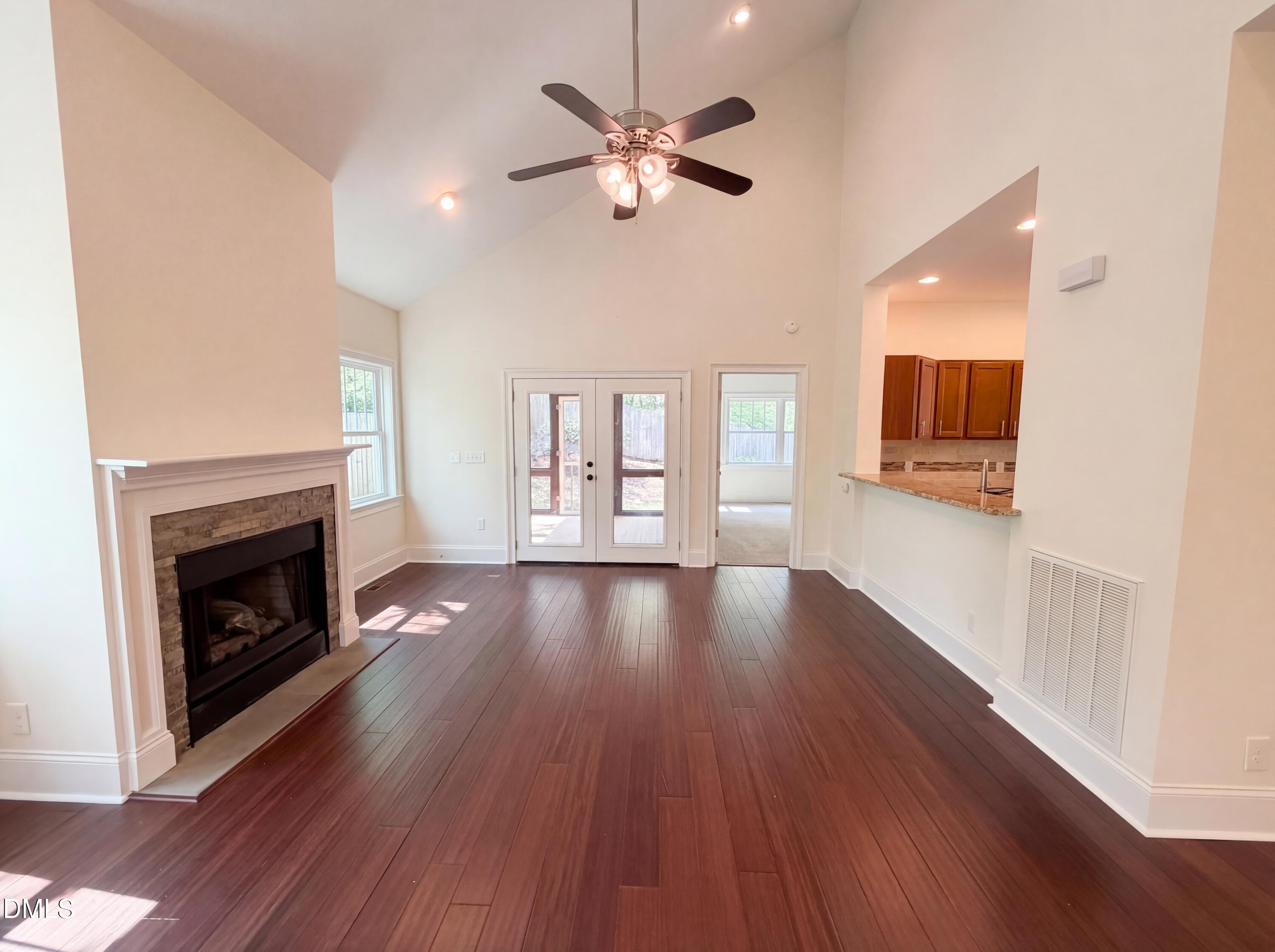 1007 Hazel Street Durham, NC 27701 - Photo 3 of 17 a view of an empty room with wooden floor and a fireplace