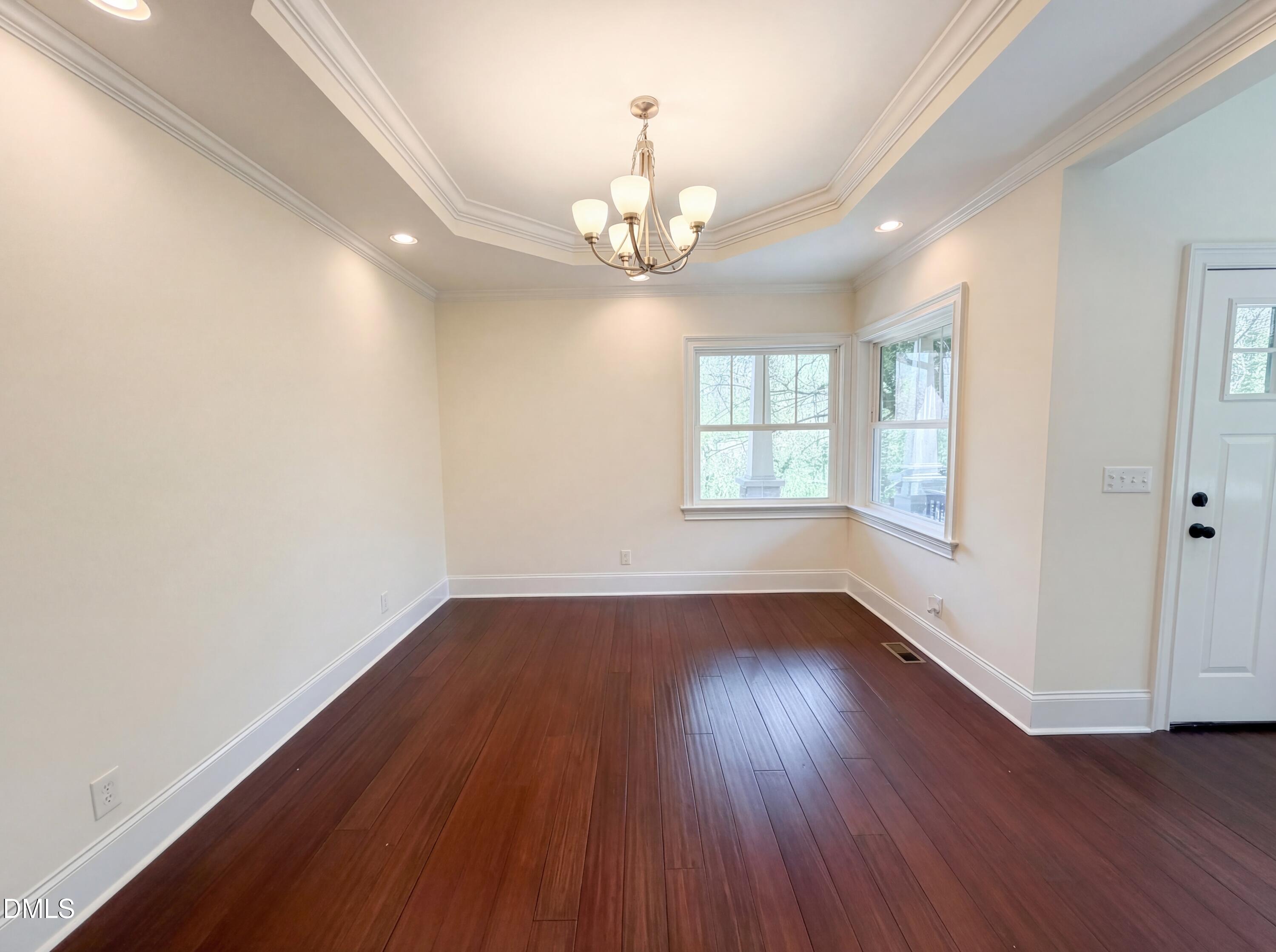 1007 Hazel Street Durham, NC 27701 - Photo 9 of 17 an empty room with wooden floor and windows
