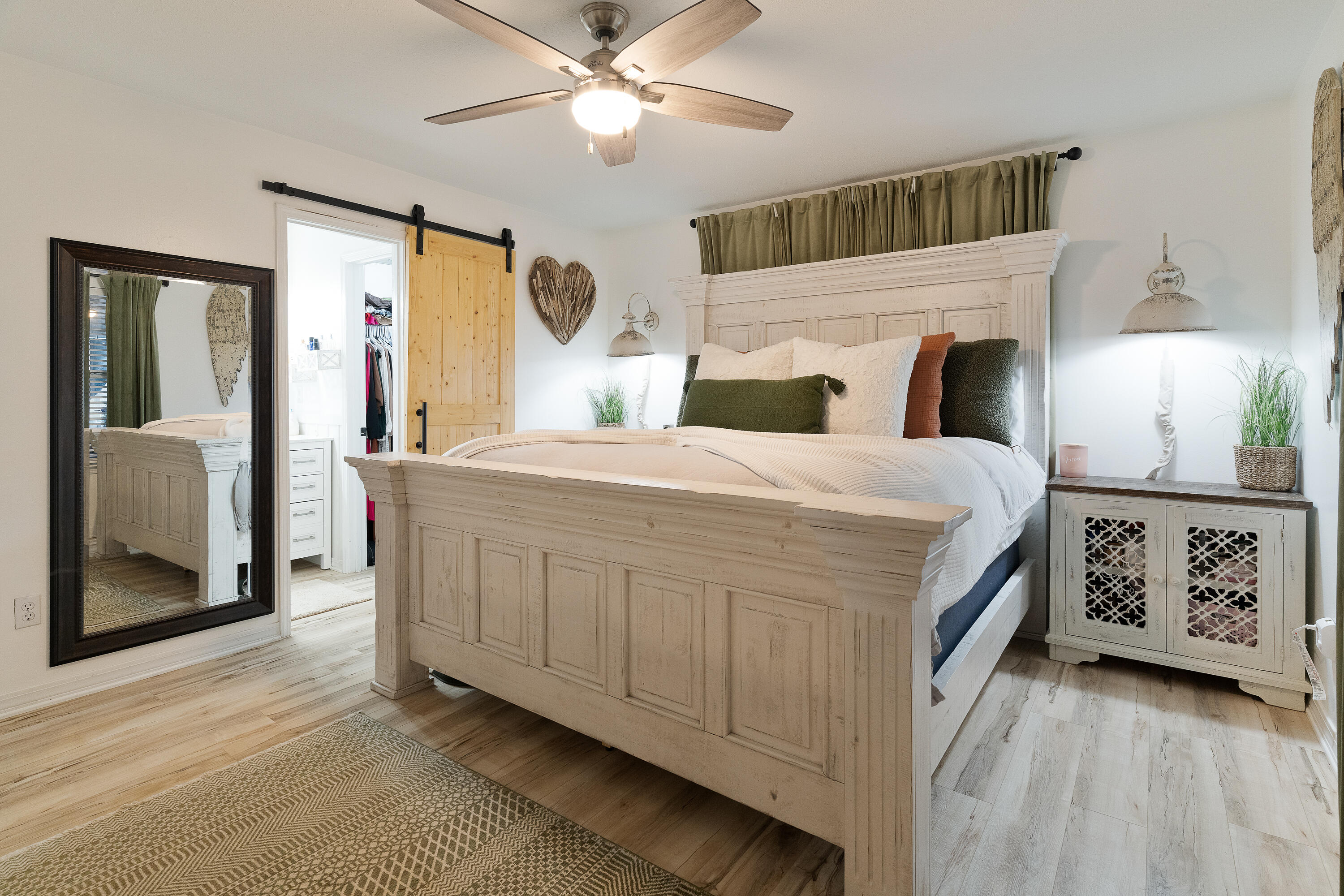 125 Wright Circle Niceville, FL 32578 - Photo 21 of 51 a bedroom with a large bed a chandelier and dresser