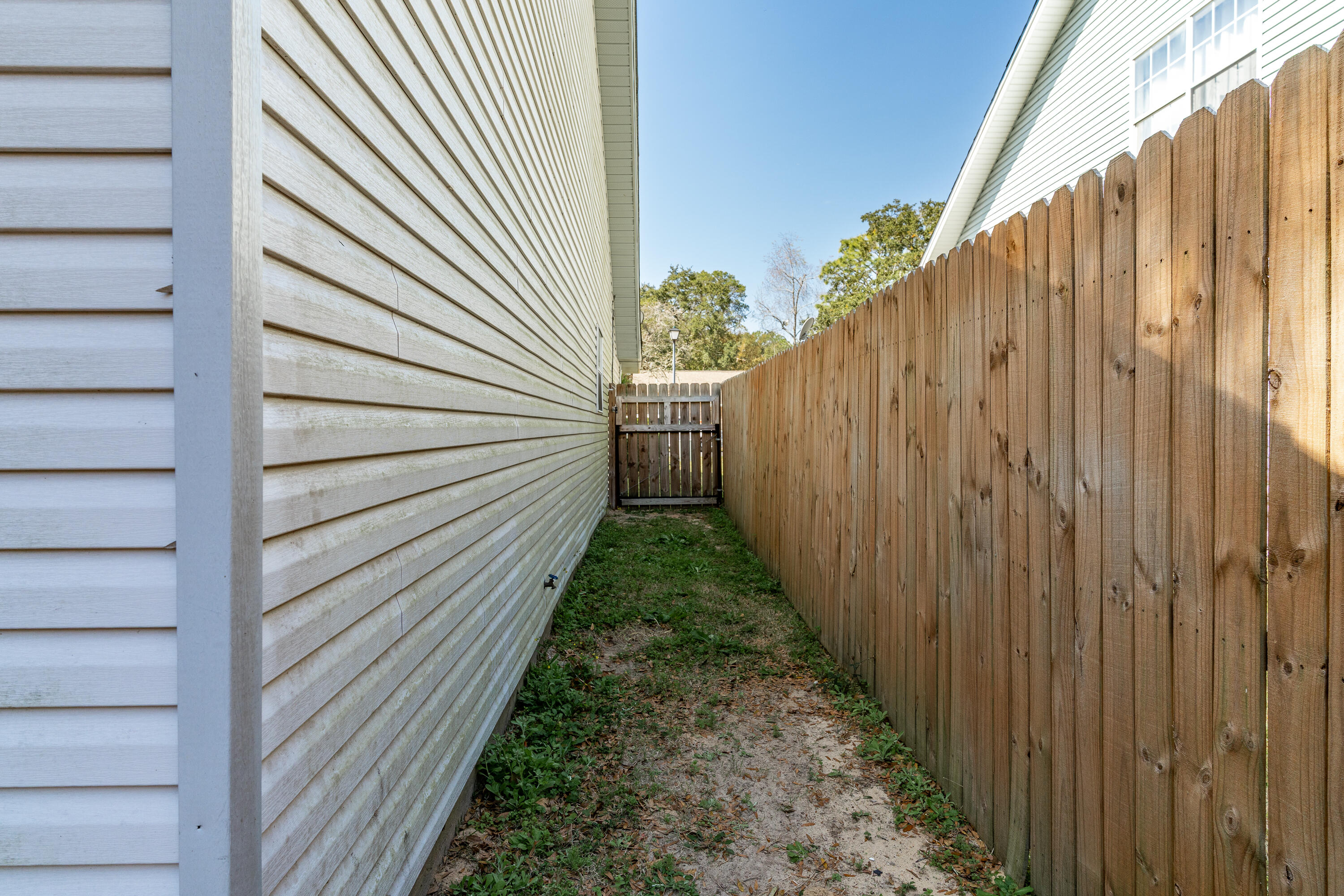 125 Wright Circle Niceville, FL 32578 - Photo 42 of 51 a view of a pathway with a wooden fence