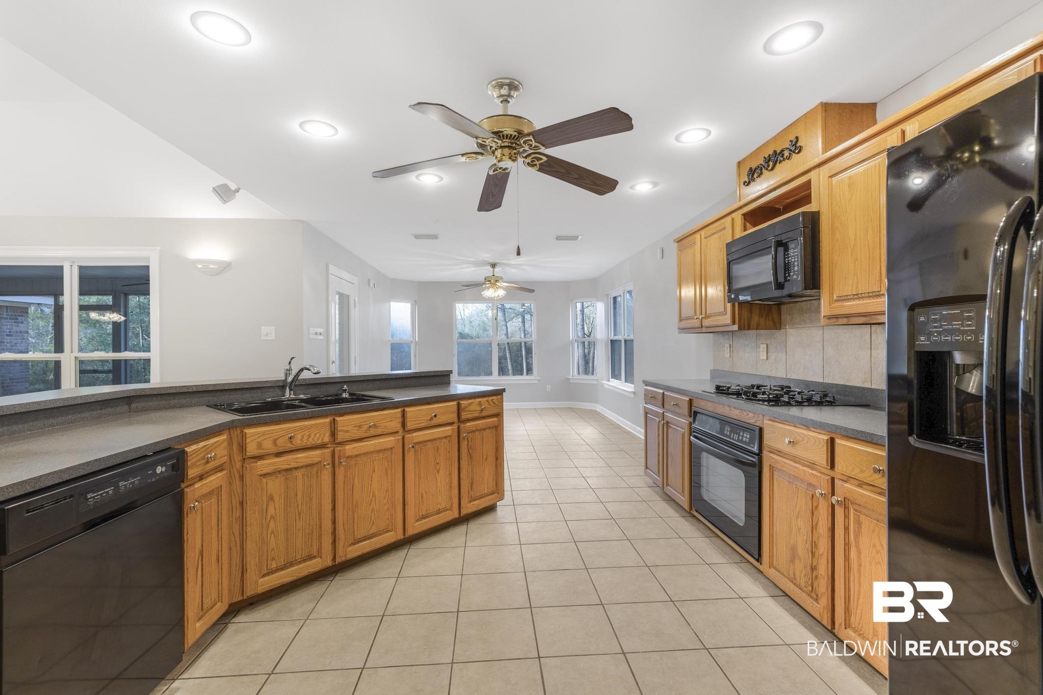 8077 Hooks Road Bay Minette, AL 36507 - Photo 3 of 48 Kitchen featuring black appliances, dark countertops, decorative backsplash, light tile patterned floors, and recessed lighting