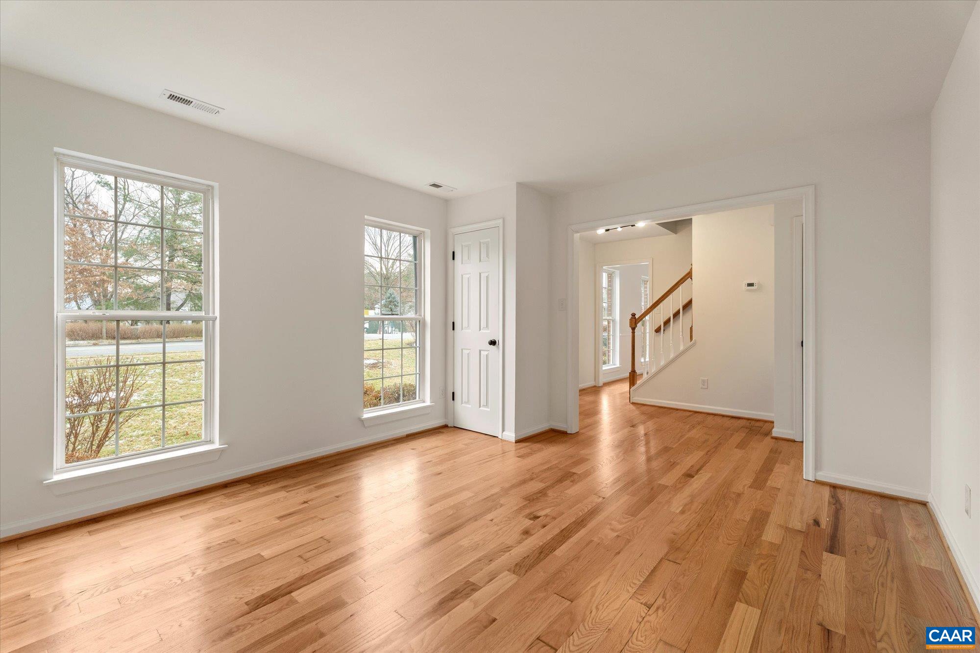 1600 Old Brook Road Charlottesville, VA 22901 - Photo 7 of 48 a view of an empty room with wooden floor and a window