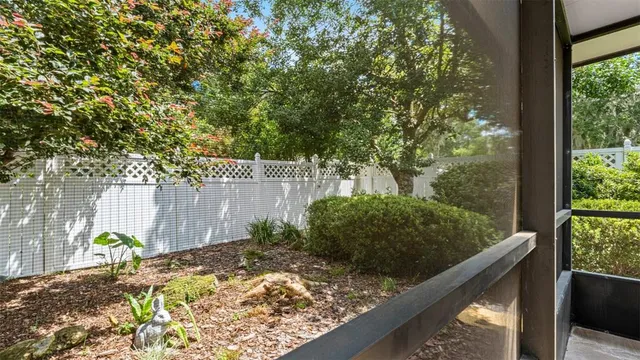 a view of a porch with chairs and backyard