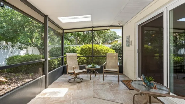 a dining room with furniture water view and a floor to ceiling window