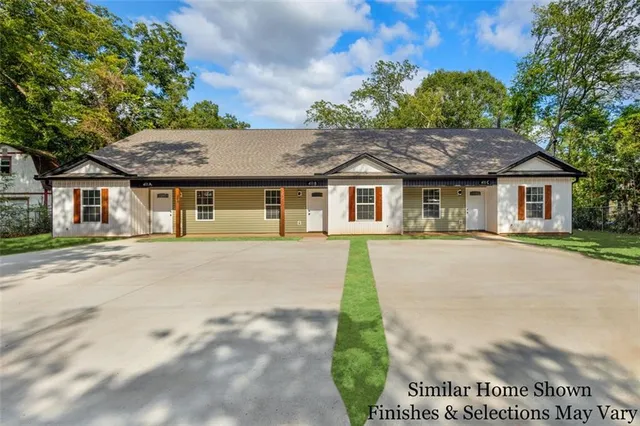 a front view of a house with a garden