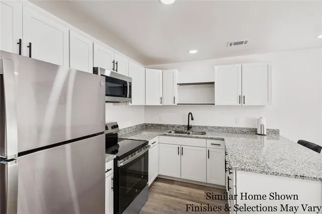 a kitchen with a refrigerator sink and microwave