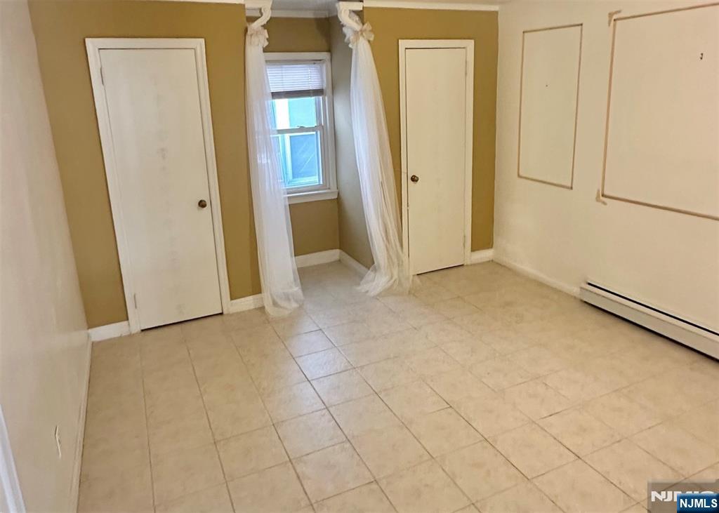 90 Clark Street Garfield, NJ 07026 - Photo 13 of 17 an empty room with windows