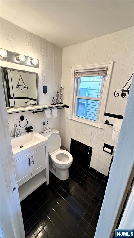90 Clark Street Garfield, NJ 07026 - Photo 6 of 17 a bathroom with a toilet sink and mirror