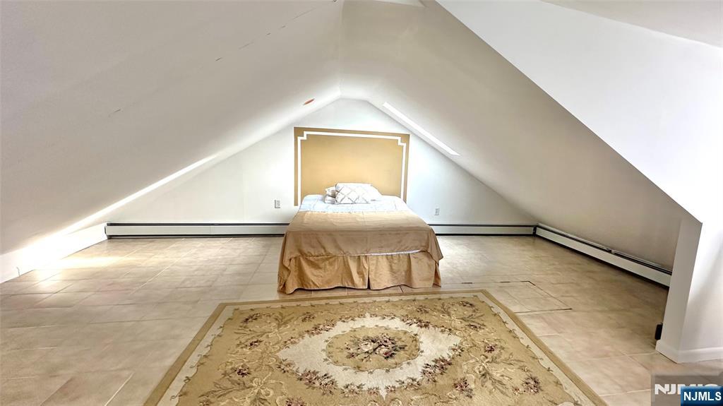 90 Clark Street Garfield, NJ 07026 - Photo 9 of 17 a room with a bed and a couch