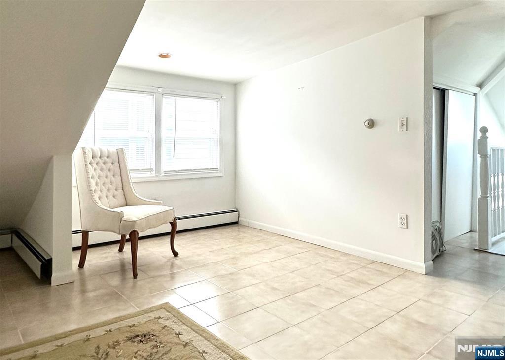 90 Clark Street Garfield, NJ 07026 - Photo 10 of 17 a living room with furniture and a window
