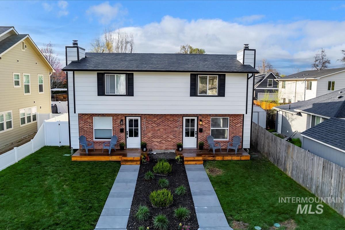 918 North 32nd Street Boise, ID 83702 - Photo 1 of 1 View of front of property with a chimney, a wooden deck, brick siding, and a fenced backyard