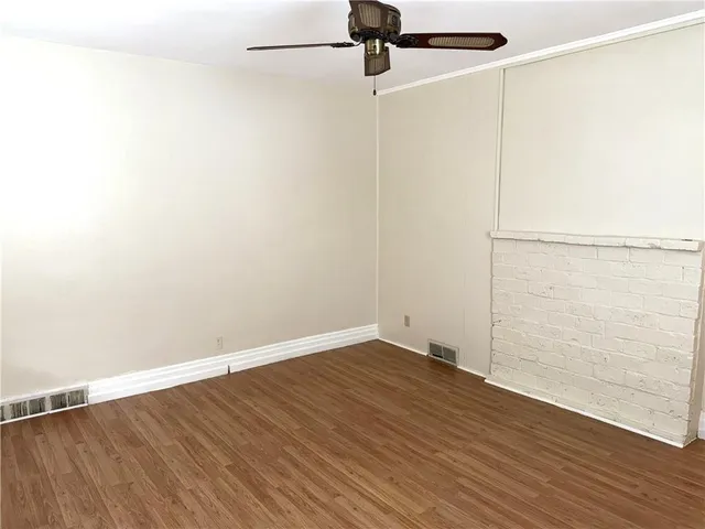 a view of a room with wooden floor
