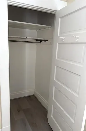 a view of walk in closet with empty racks
