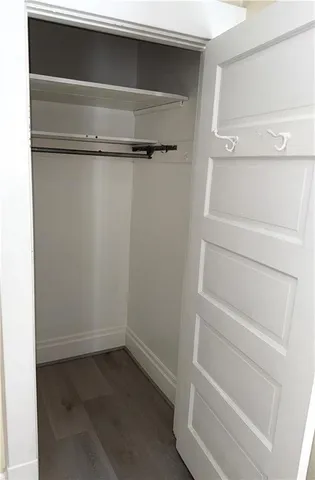a view of walk in closet with empty racks