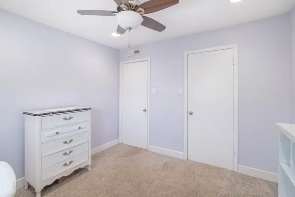a view of an empty room with a cabinet