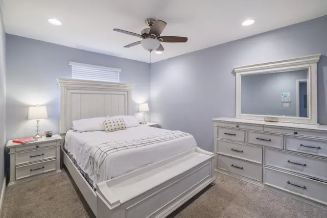 a bedroom with a bed and a dresser