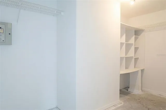 a view of walk in closet with empty racks
