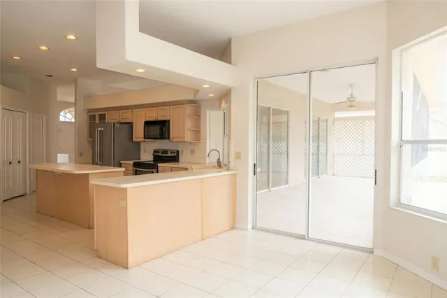 a view of kitchen with kitchen island and white cabinets