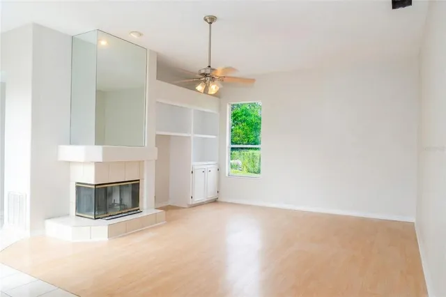 a view of a livingroom with a fireplace and a window