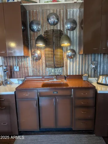 a view of a patio with a table and chairs under an umbrella