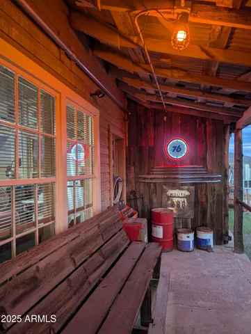 a kitchen with stainless steel appliances granite countertop a sink a stove a dining table and chairs with wooden floor