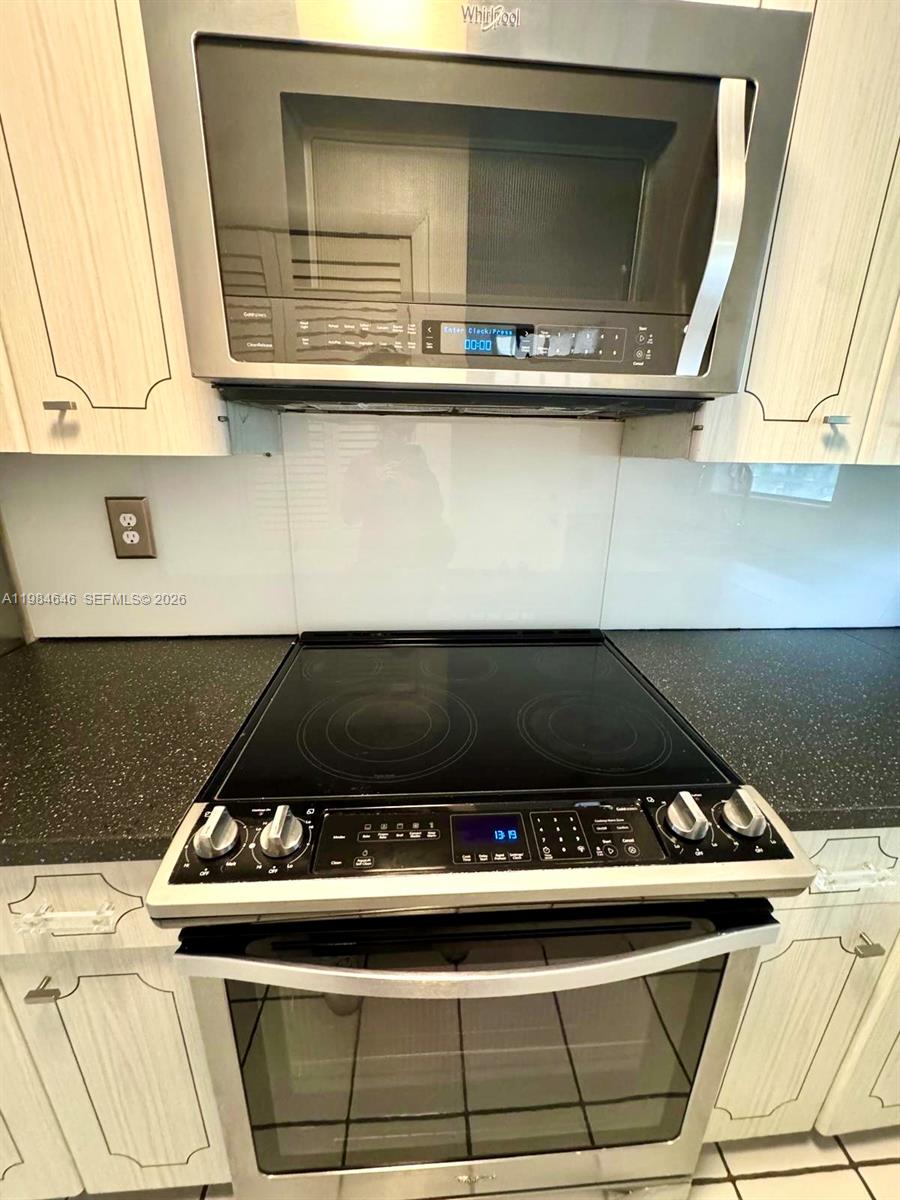 2501 South Ocean Boulevard, Unit 1040 Boca Raton, FL 33432 - Photo 11 of 16 a stove top oven sitting inside of a kitchen