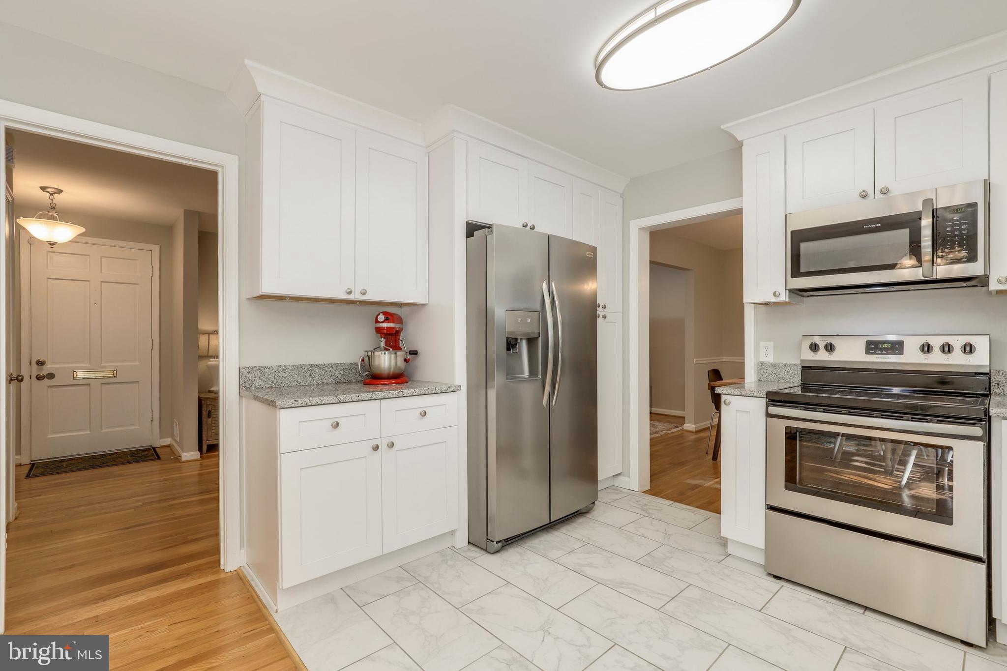 8461 Thames Street Springfield, VA 22151 - Photo 13 of 57 a kitchen with granite countertop a refrigerator stove and microwave