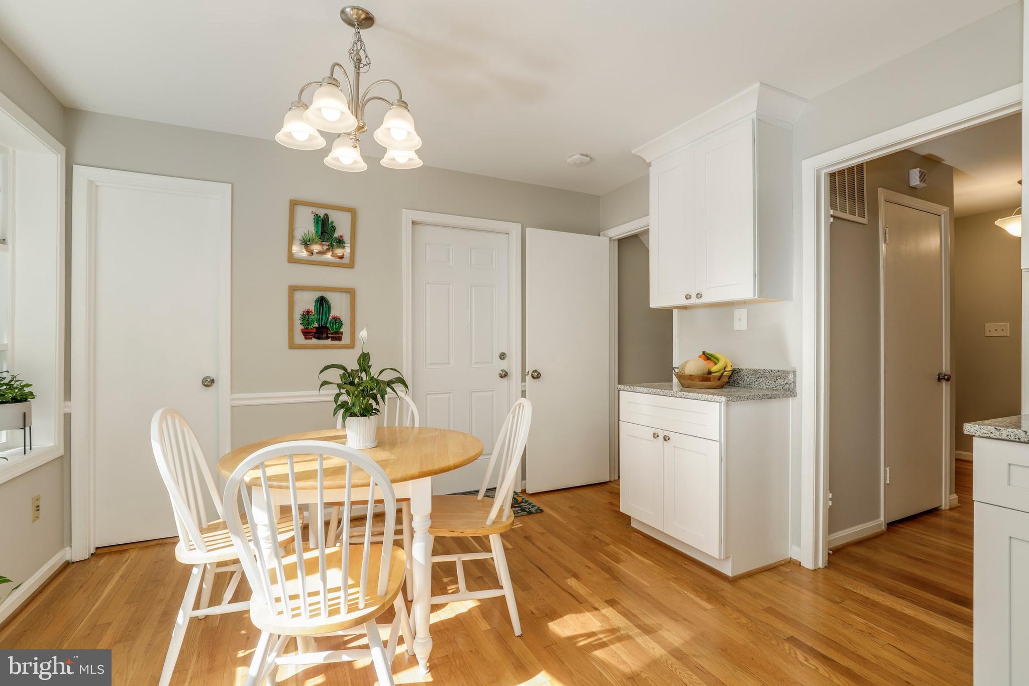 8461 Thames Street Springfield, VA 22151 - Photo 14 of 57 a view of a dining room with furniture and wooden floor