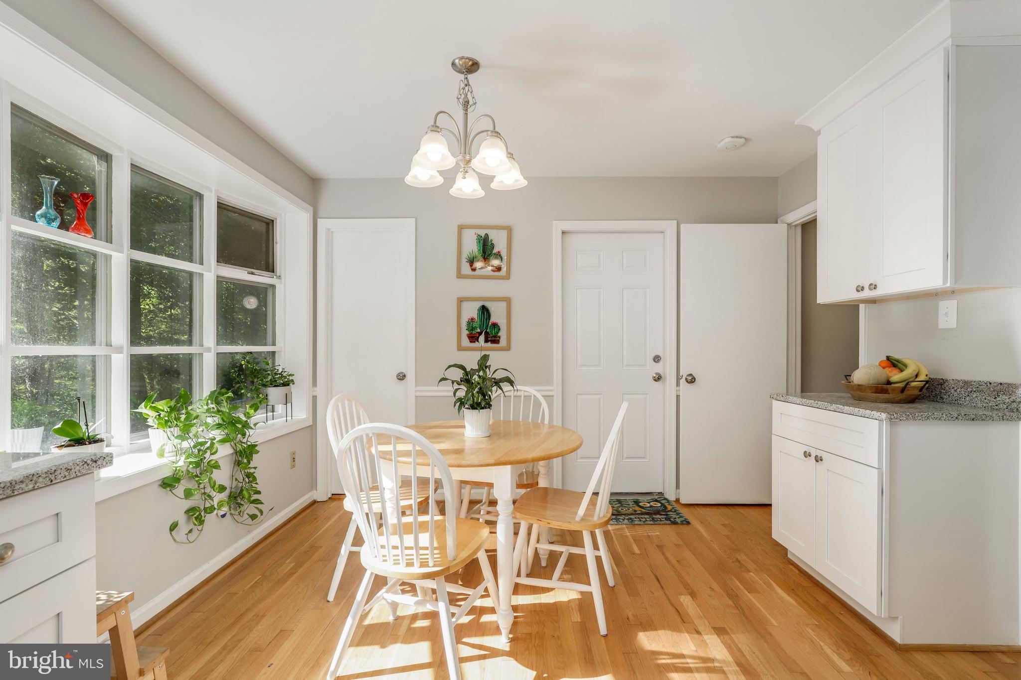 8461 Thames Street Springfield, VA 22151 - Photo 15 of 57 a view of a dining room with furniture and a chandelier