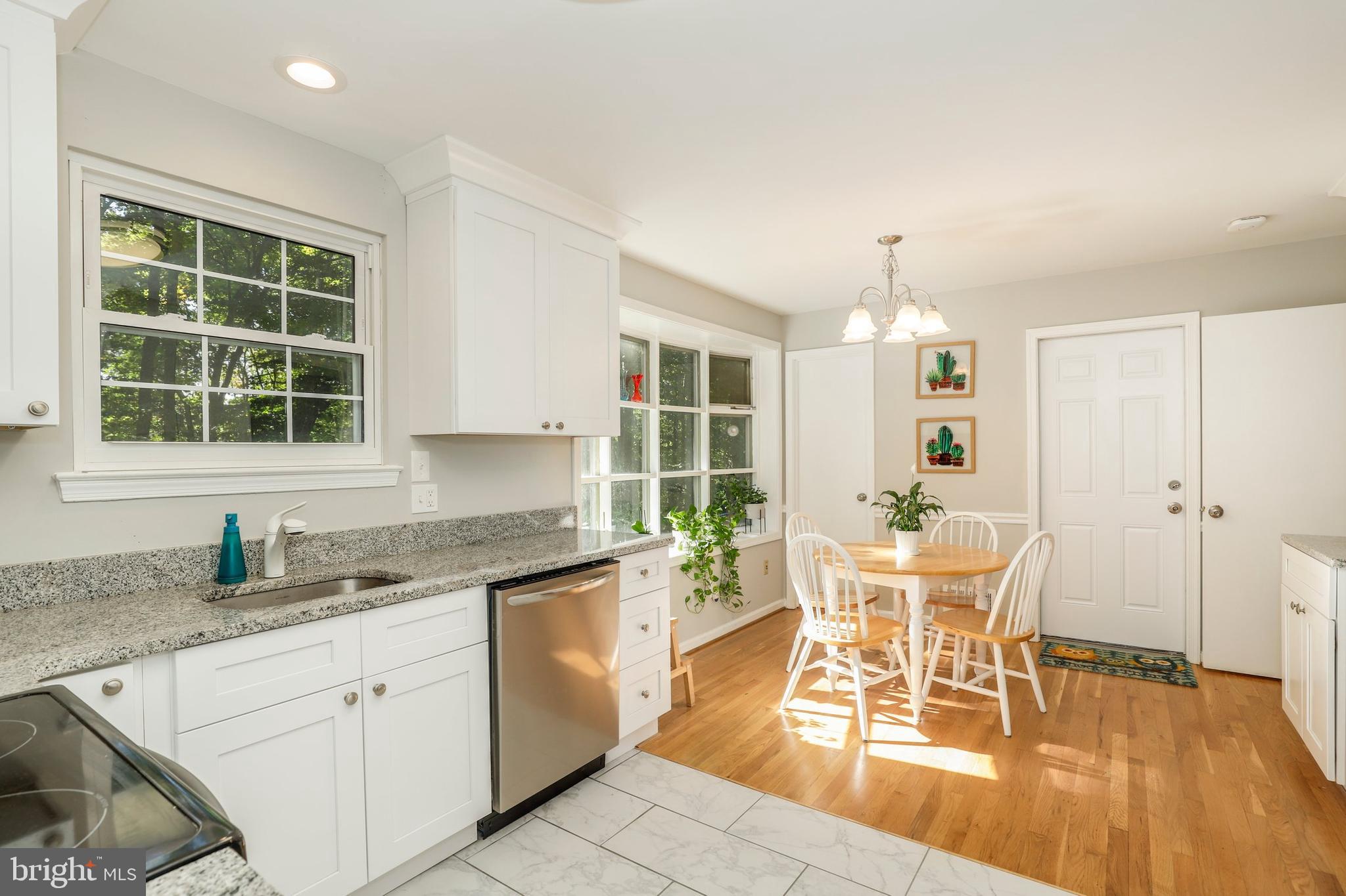 8461 Thames Street Springfield, VA 22151 - Photo 16 of 57 a kitchen with a dining table chairs and large window