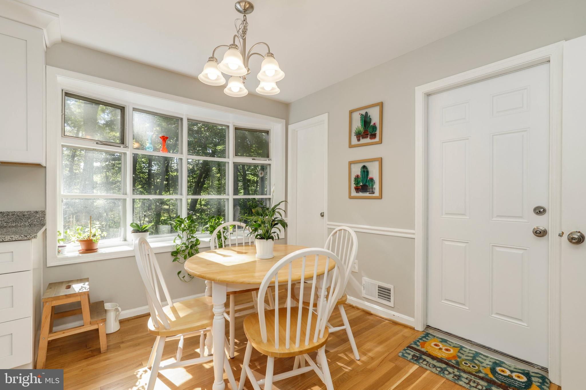 8461 Thames Street Springfield, VA 22151 - Photo 17 of 57 a dining room with furniture a chandelier and wooden floor