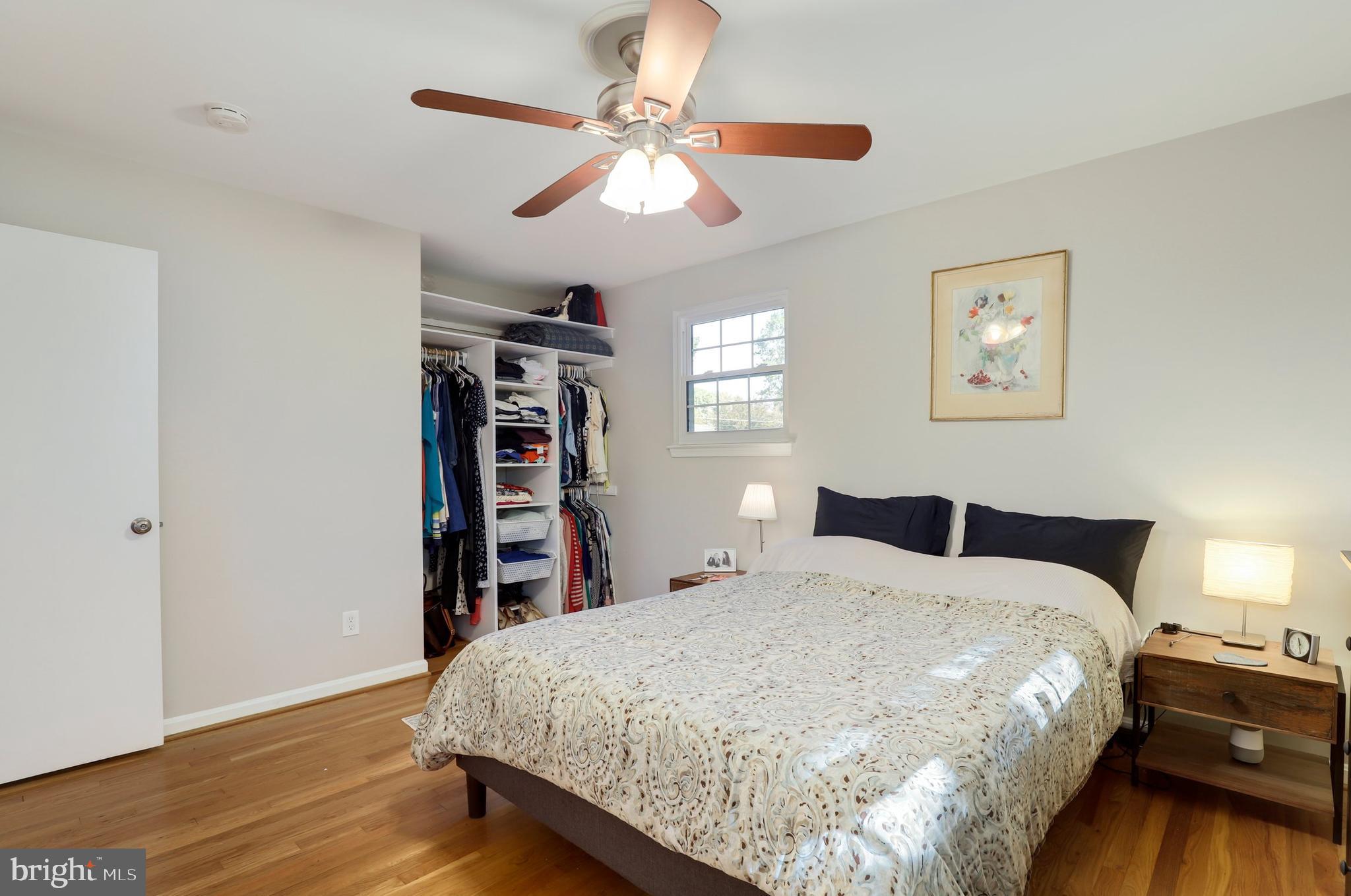 8461 Thames Street Springfield, VA 22151 - Photo 31 of 57 a bedroom with a large bed and a chandelier