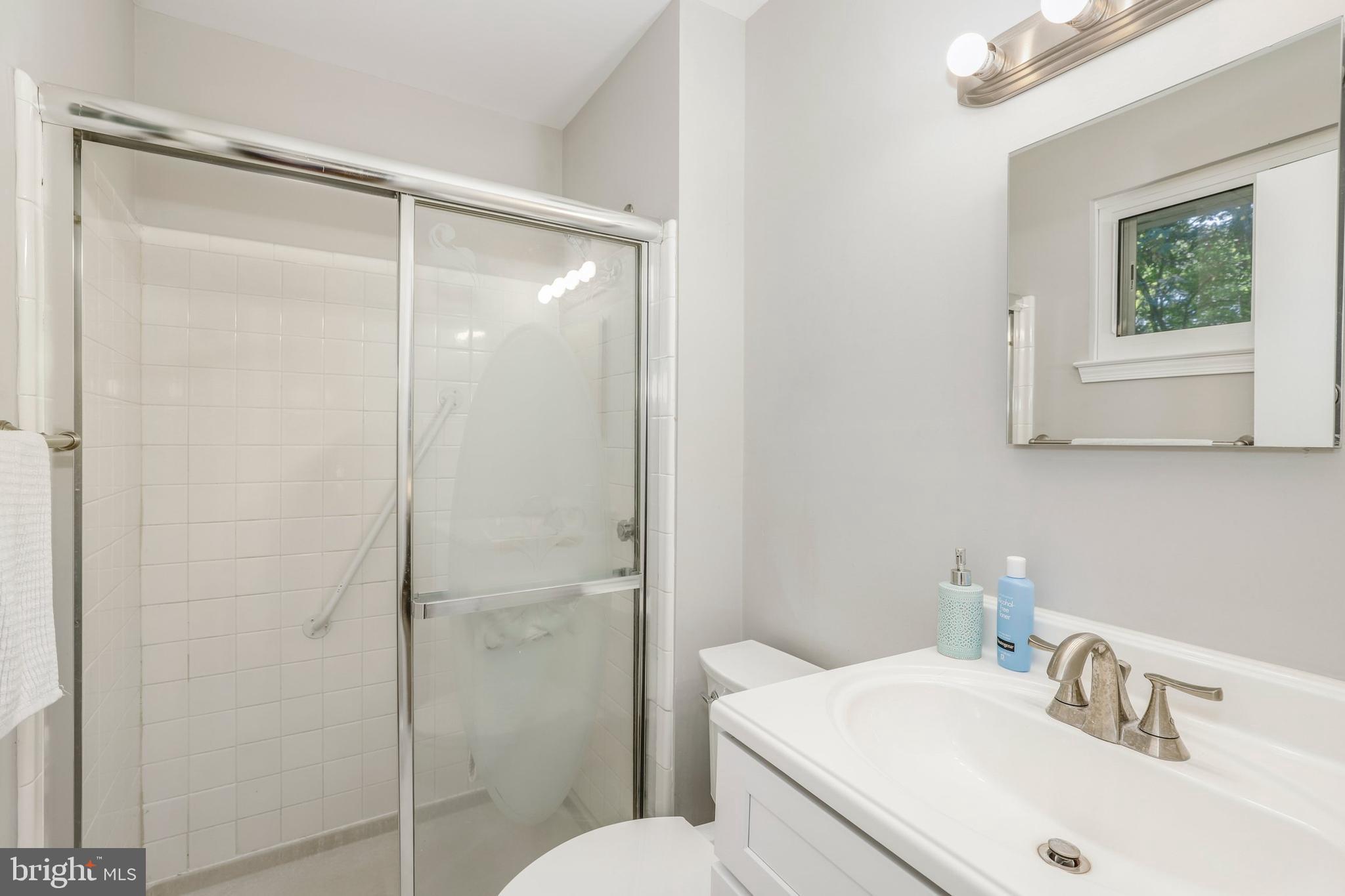 8461 Thames Street Springfield, VA 22151 - Photo 32 of 57 a bathroom with a sink a toilet and shower