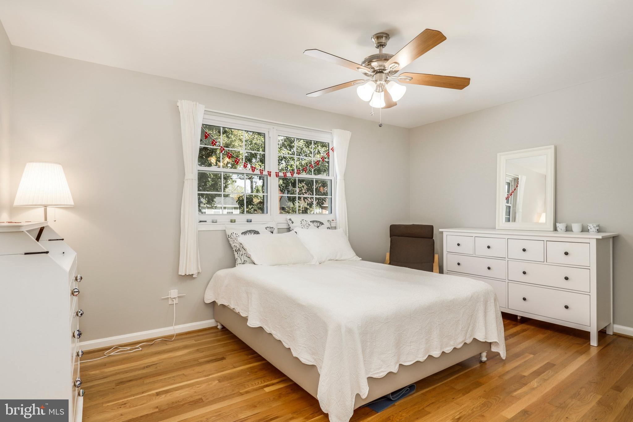 8461 Thames Street Springfield, VA 22151 - Photo 33 of 57 a bedroom with a large bed and a chandelier