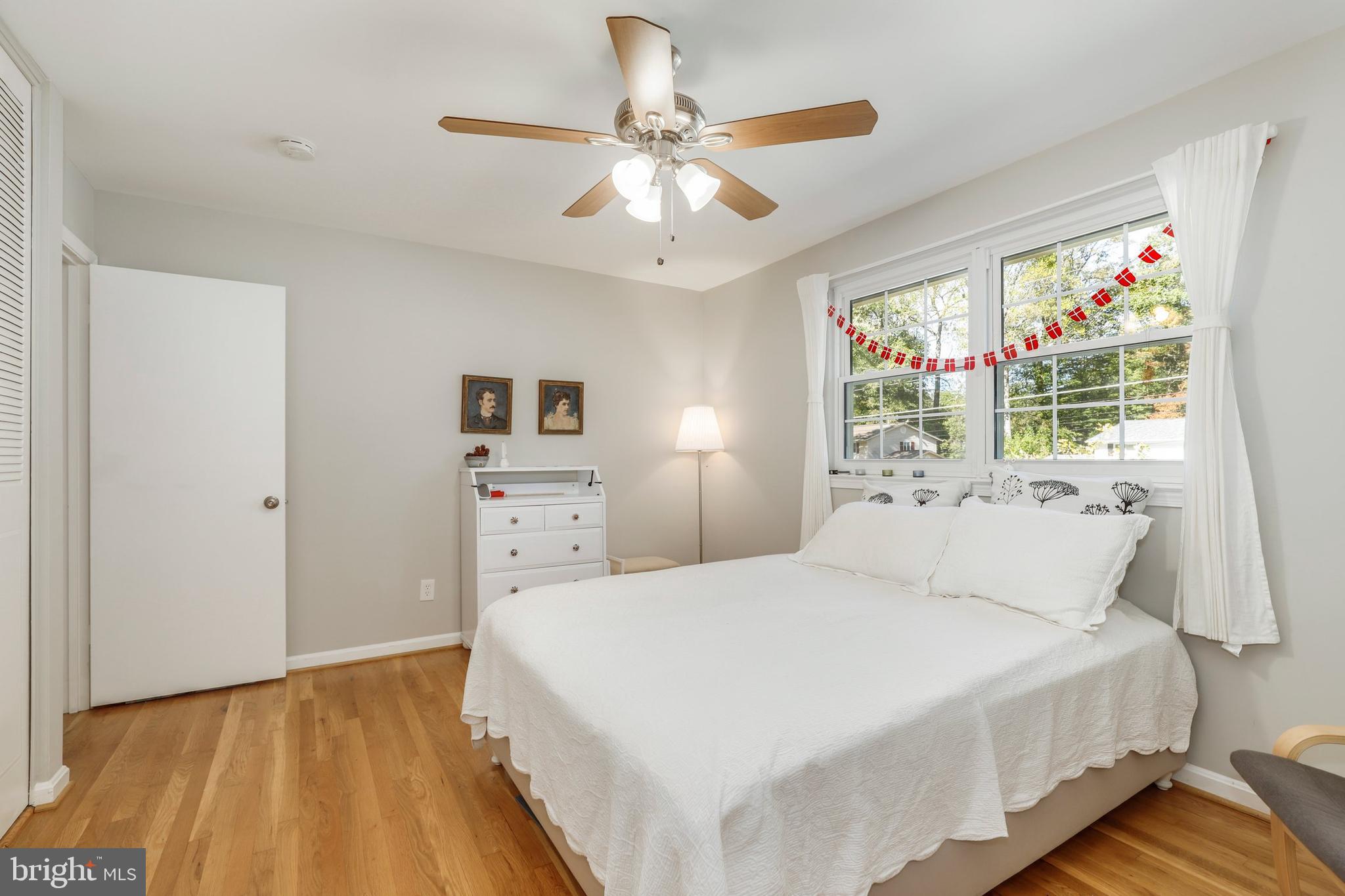 8461 Thames Street Springfield, VA 22151 - Photo 34 of 57 a spacious bedroom with a bed and a chandelier